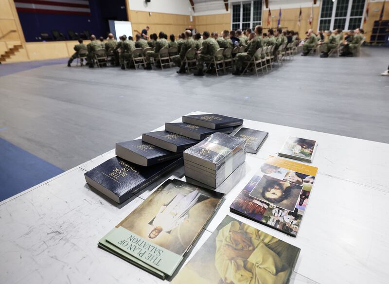 U.S. Naval officer candidates listen during the Sailors’ Devotional not far from a table with books and materials in Newport, Rhode Island.