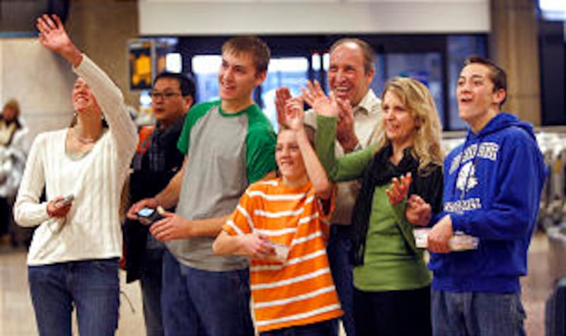 James and Cindy Hawkins and four of their six children react to seeing Elder Kevin Hawkins and Siste