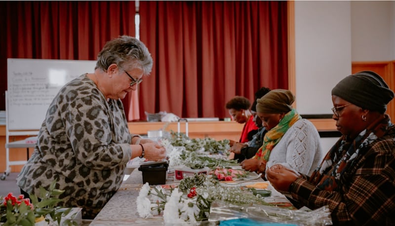 Joanna Zafirakou, a floristry instructor, teaches beginning commercial floristry to community members at the Wembley Friendship and Outreach Center.