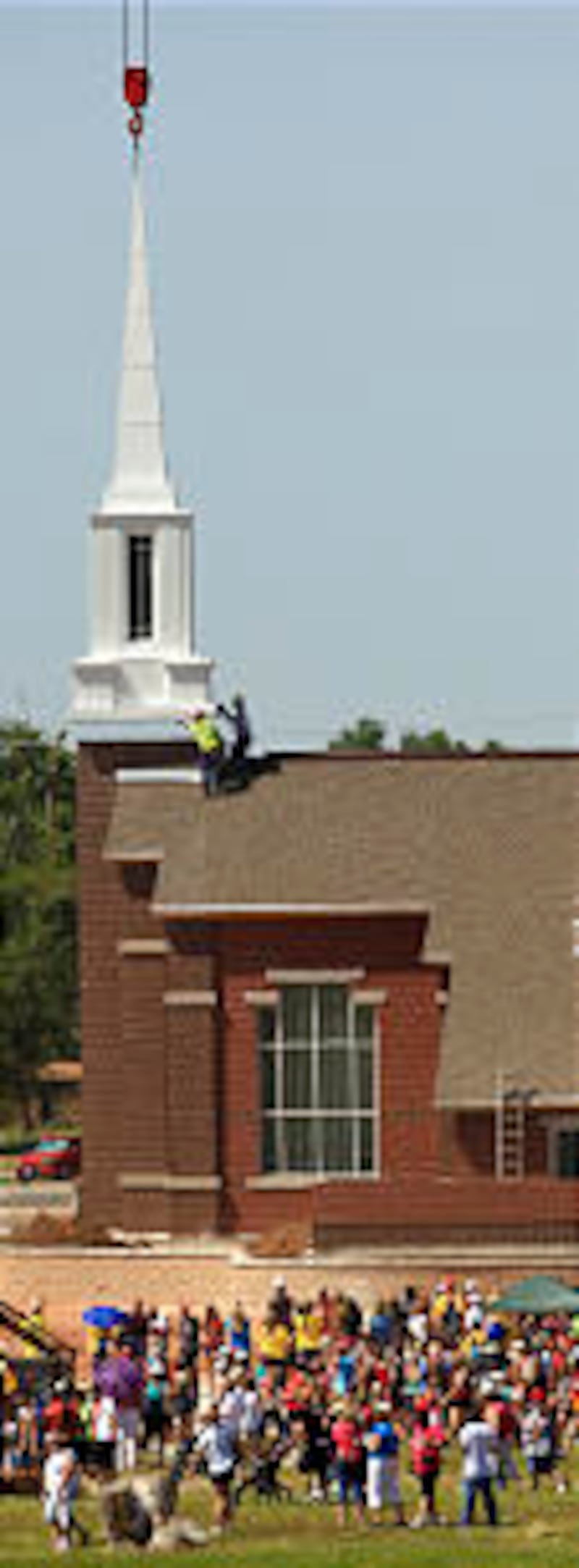 At the one-year anniversary remembrance of the tornado in Joplin, Mo., a new steeple was placed on t