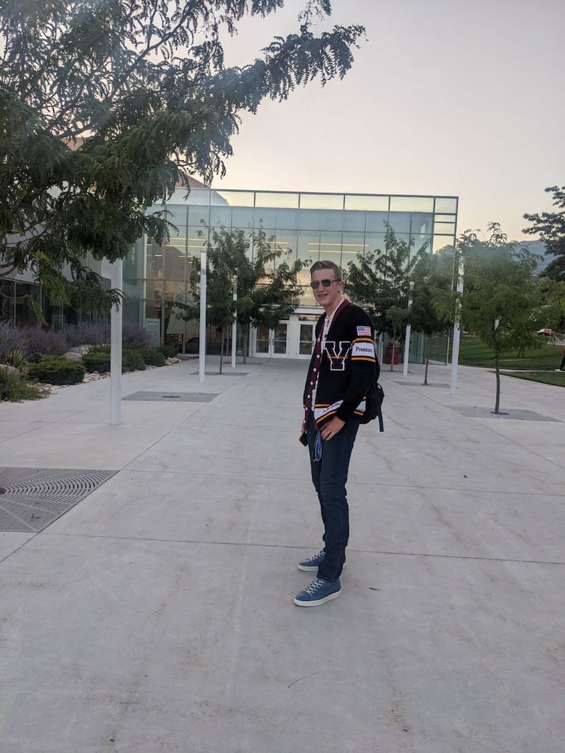 Preston Page smiles while wearing his senior class officer jacket.
