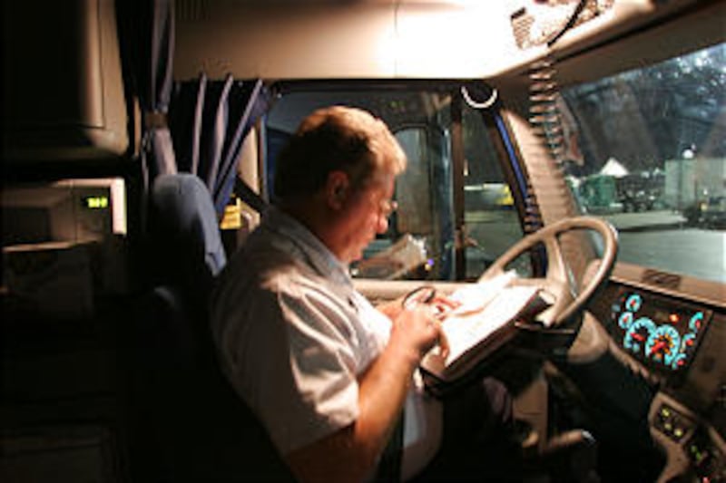 Deseret Transportation driver Allen Humphries plans route to Albuquerque, N.M., while stopped in Far