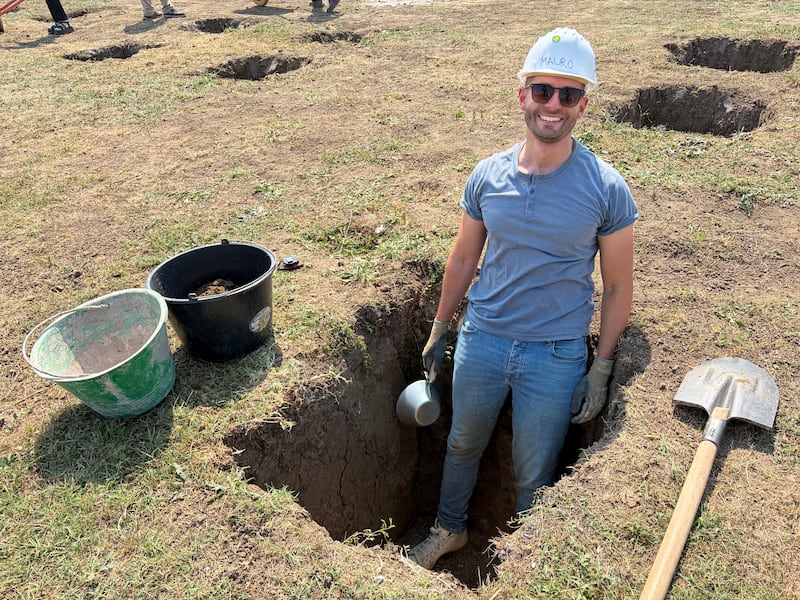 Mauro Dicataldo, a volunteer who traveled from Paris, Frace, works inside a foundation hole during a Habitat for Humanity Romania service project in Berceni, Romania, in August 2026.
