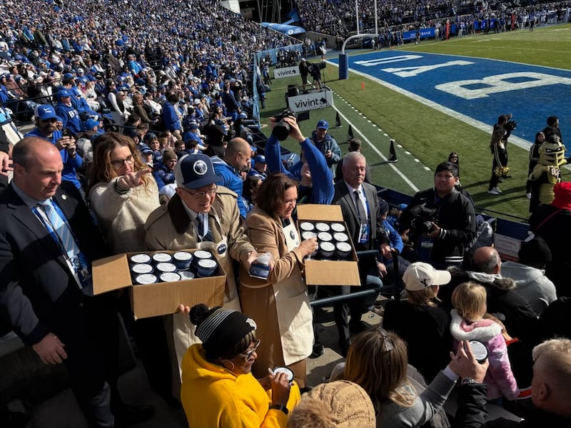 Elder Gerrit W. Gong and Sister Susan Gong engage in ice cream diplomacy, handing out free treats to UCF fans.