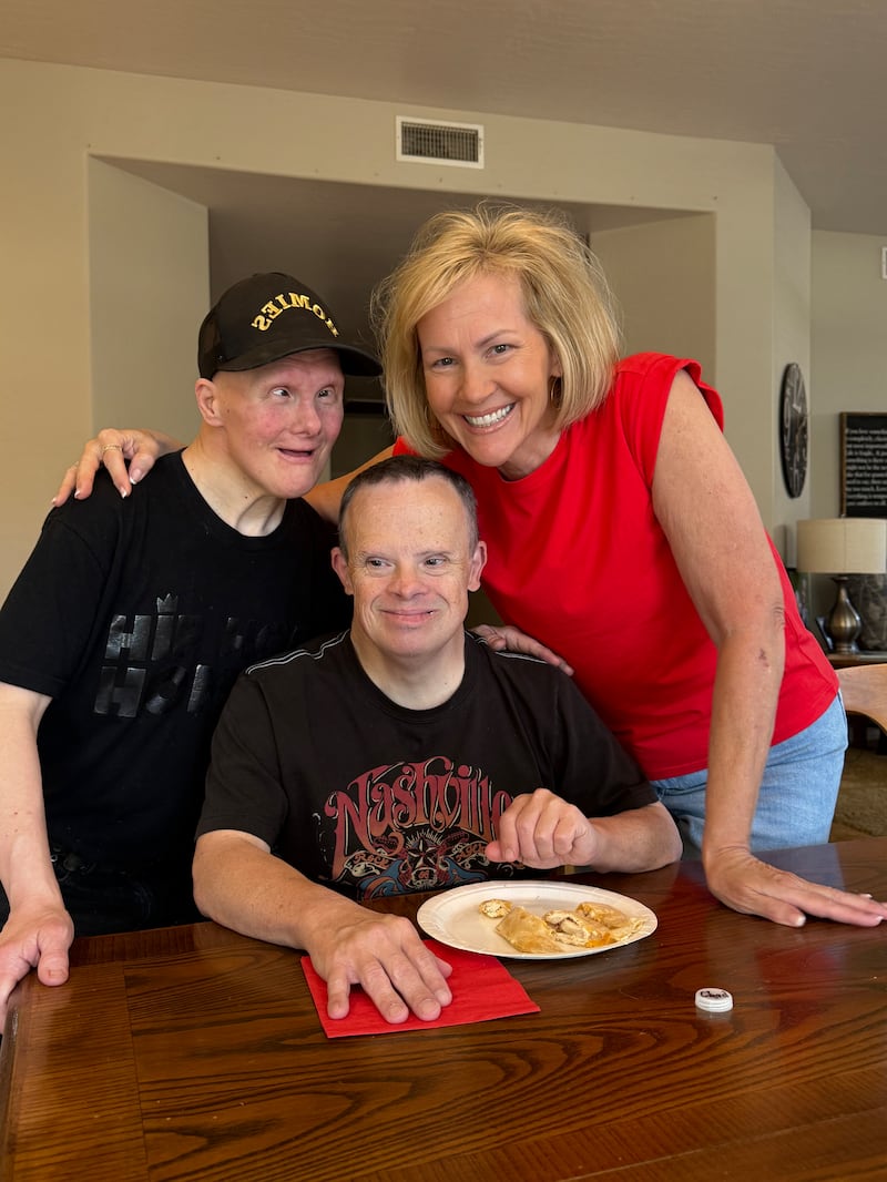 From left to right: Kelly Leavitt, Chad Rades and Carol Tingey smile for a photo in Mesa, Arizona, on July 10, 2025. These three individuals have been friends since high school.