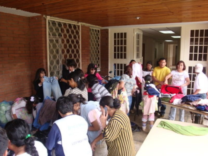 Members from the Quetzaltenango Guatemala El Bosque Stake collect and sort donated clothing to be di