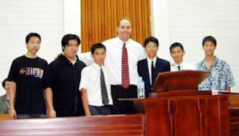 NFL player Chad Lewis, center, extends friendship to youth of Taichung Taiwan Stake.