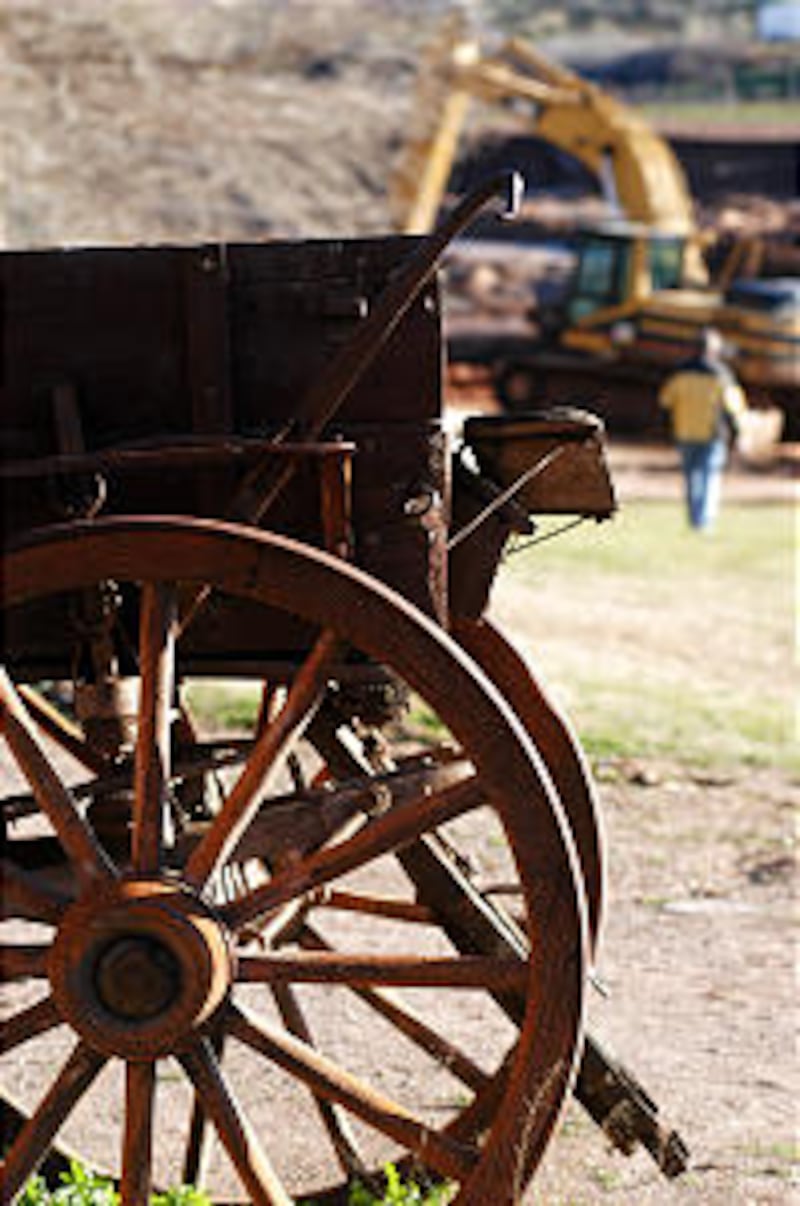 Pioneer wagon outside historic Jacob Hamblin home stands in stark contrast to the large equipment in