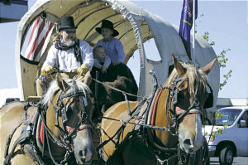 With grandchildren in wagon, Clyde Bradford, Spanish Fork, drives horses Rock and Dick.