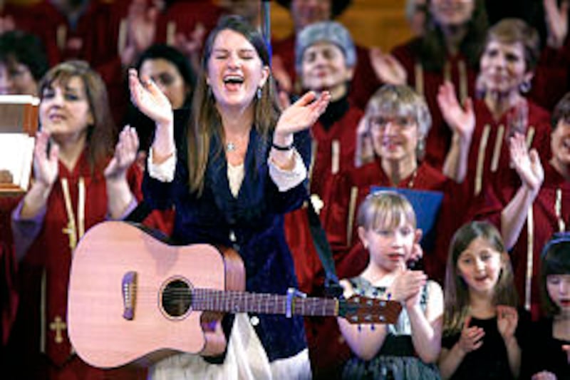 Karen Nielsen-Anson sings along with the Congregation Kol Ami Jewish Children's Choir during the In