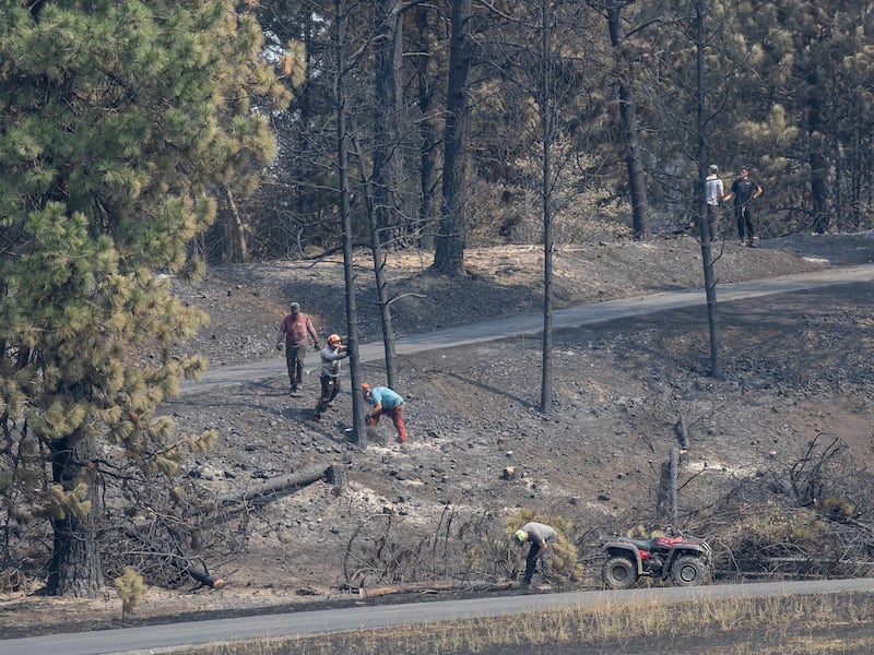Young men and leaders from the Spokane Washington Mount Spokane Stake help clear debris from a neighborhood damaged by wildfires in Spokane, Washington, on Monday, Aug. 3, 2026.