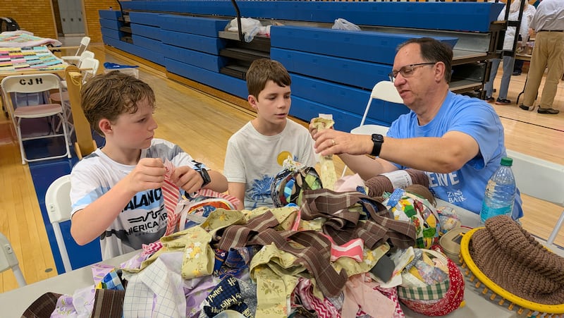Don Love shows Noah Keeler (left) and Ben Keeler (center) how to create rag balls as part of a National Day of Service and Remembrance event in Centerville, Utah, on Saturday, Sept. 12, 2026.