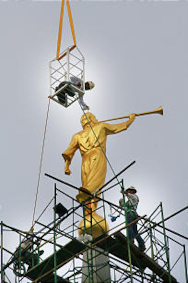 The statue of Moroni is hoisted high atop the Cebu Philippines Temple.