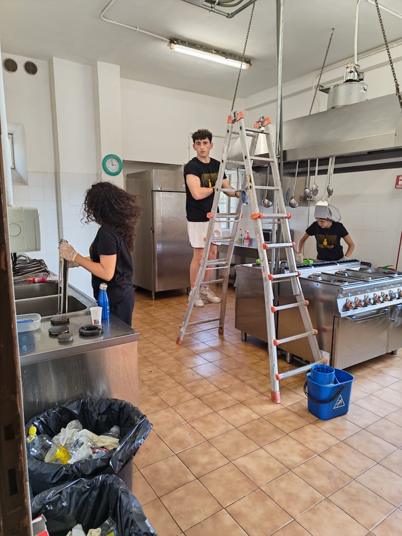 Young single adults from Malta and Sicily clean the kitchen and equipment at Casa Scalabrini 634 in Rome, Italy.
