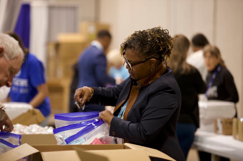 Volunteers make hygiene kits for a JustServe project at the National League of Cities summit in Salt Lake City on Thursday, Nov. 20, 2025.