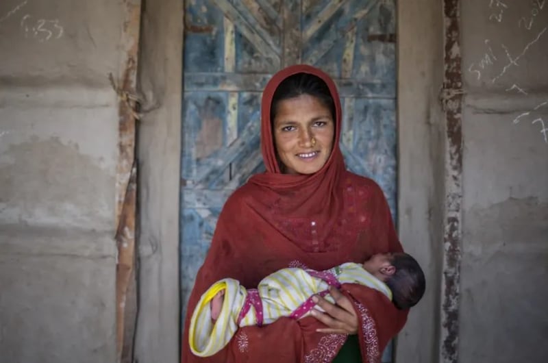 A mother holds her baby in Pakistan.