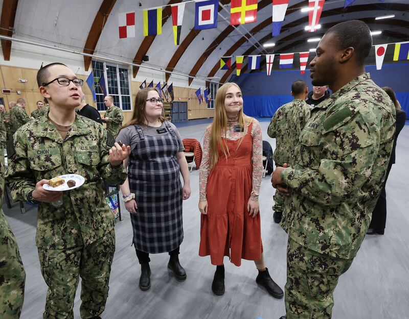 Sister missionaries talk with Naval officer candidates after the Sailors’ Devotional in Newport, Rhode Island.