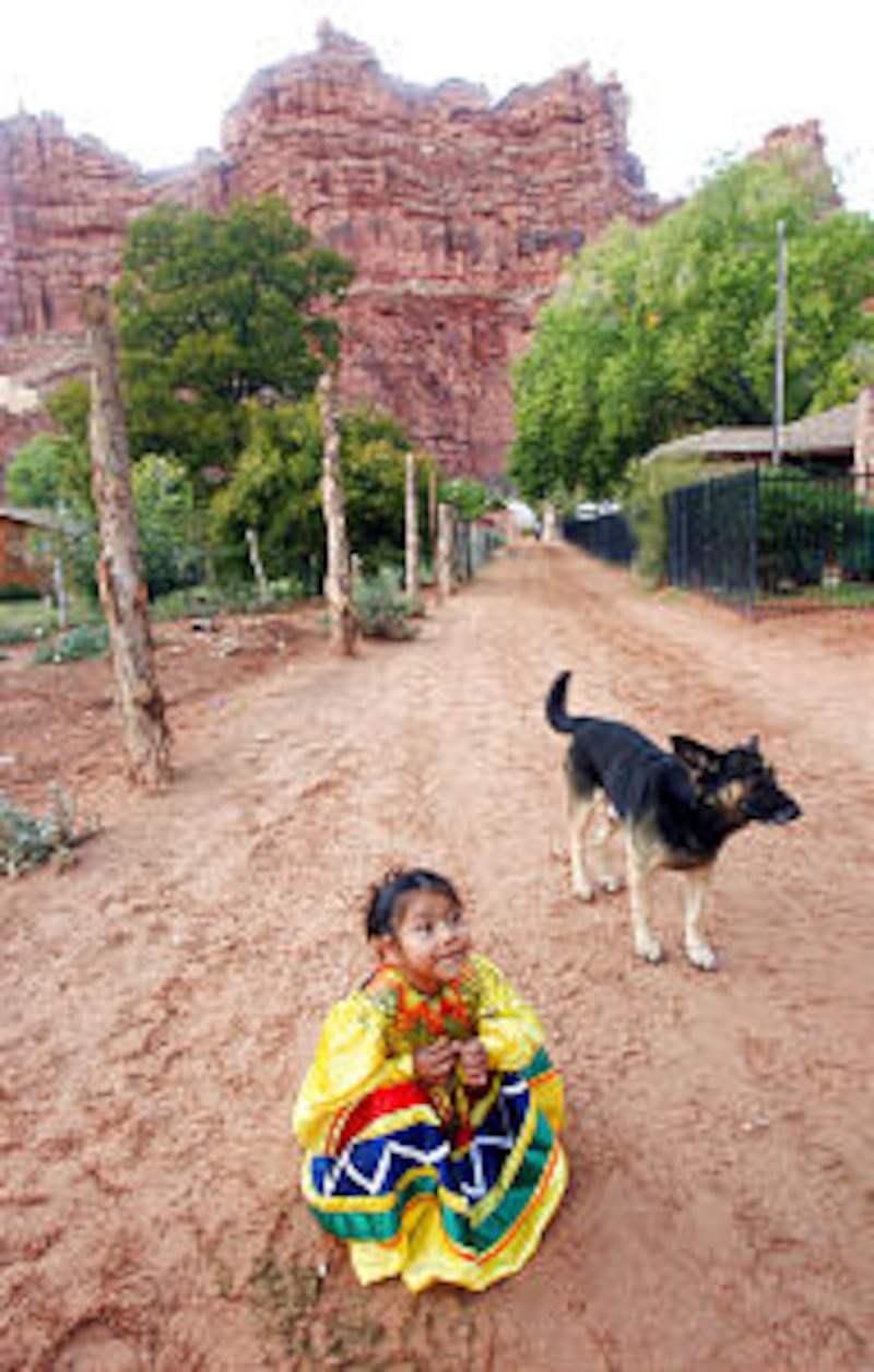 Decovan Uqualla, an LDS Chruch member, plays on the dirt street on the Havasupai Indian reservati