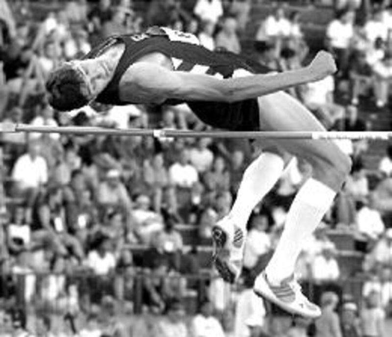 Charles Clinger of Weber State University clears bar in high jump. He now sets sights on Athens in 2
