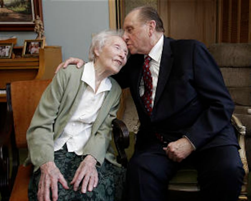 On behalf of her late husband, Percy K. Fetzer, President Monson bestows a kiss upon Thelma Fetzer's