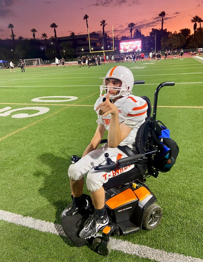 Matthew Cooper wears his football uniform in his wheelchair for a high school football game in the fall of 2024.