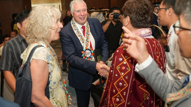 Elder Erich W. Kopischke, General Authority Seventy, center, and his wife, Sister Christiane Kopischke, left, greet participants at a religious freedom forum in Davao City, Philippines, March 25, 2026.