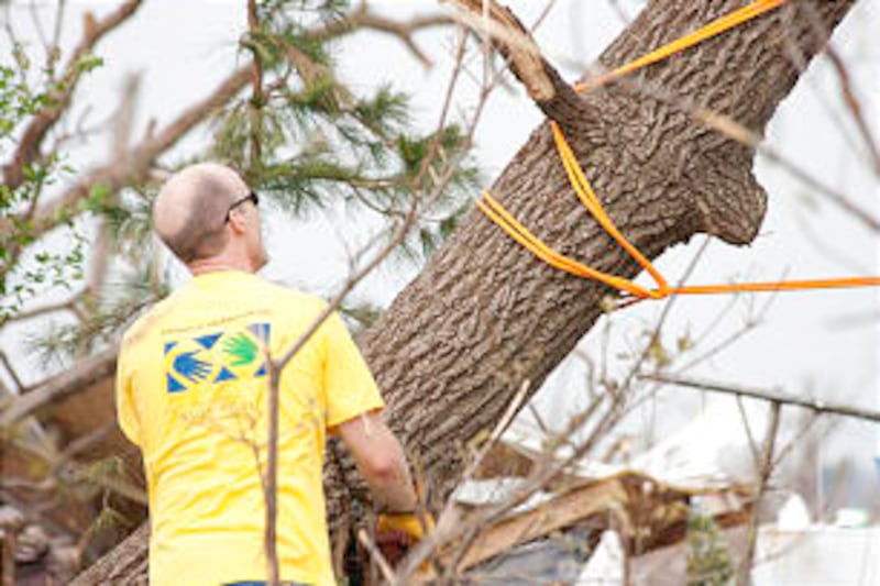 Church members wearing helping hands shirts volunteer time and effort after devastating tornado dest