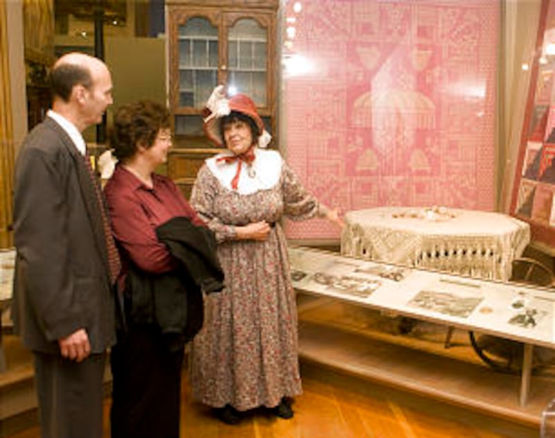 While portraying early Church member Susanna Rogers, docent Mary Helen Parsons shares a story with B