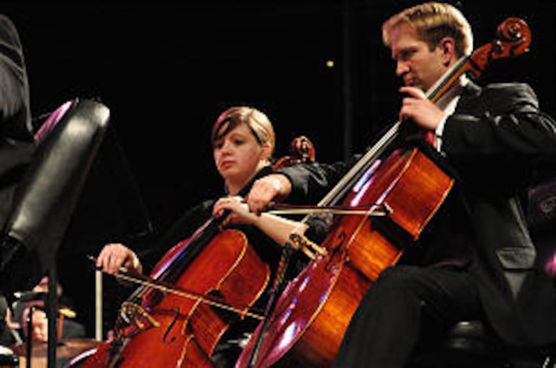 Kaitlan Allen and Steve Jones, members of the Orchestra at Temple Square, perform at the concert in