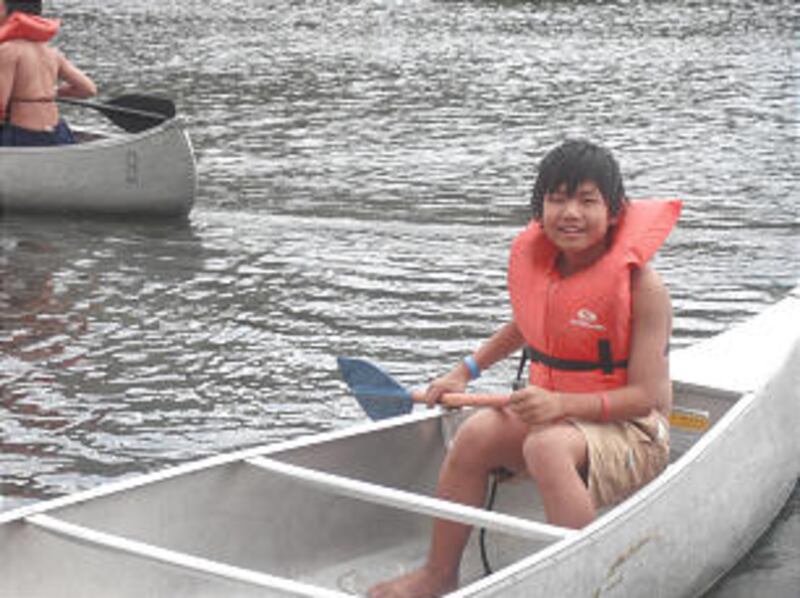 Young Scout from Troop 1262 enjoys canoeing at Scout camp.