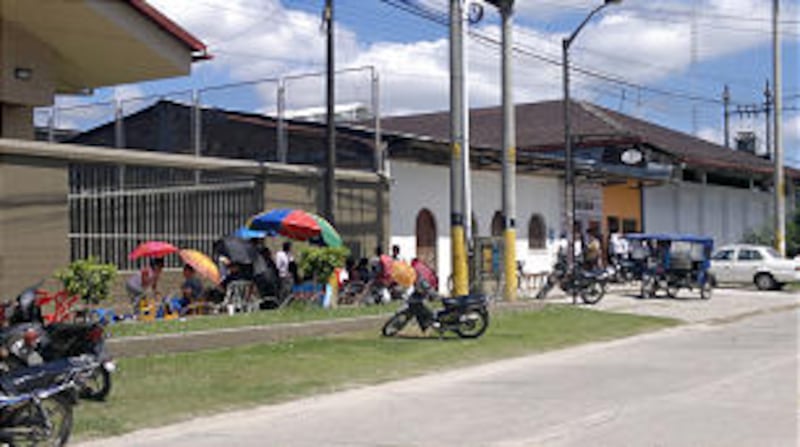 Latter-day Saints in Iquitos, Peru, line up in front of an LDS meetinghouse to attend a devotional w