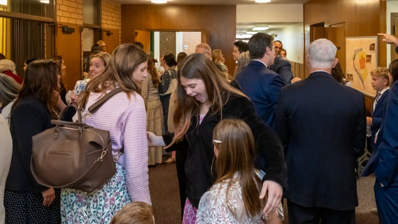 People gather inside a rededicated meetinghouse in Pacific Palisades, California, Sunday, April 12, 2026, after it suffered wildfire damage the year before.