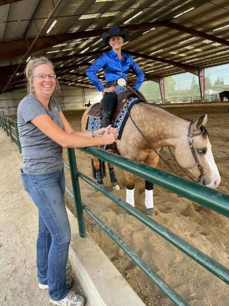 Brogan Hill, right, her horse, Quik Draw McGraw, and her mother, Melinda Rumsey, left, pause for a photo at the West Coast Reining Horse Association show in November 2023 at the Murieta Equestrian Center in Rancho Murieta, California.