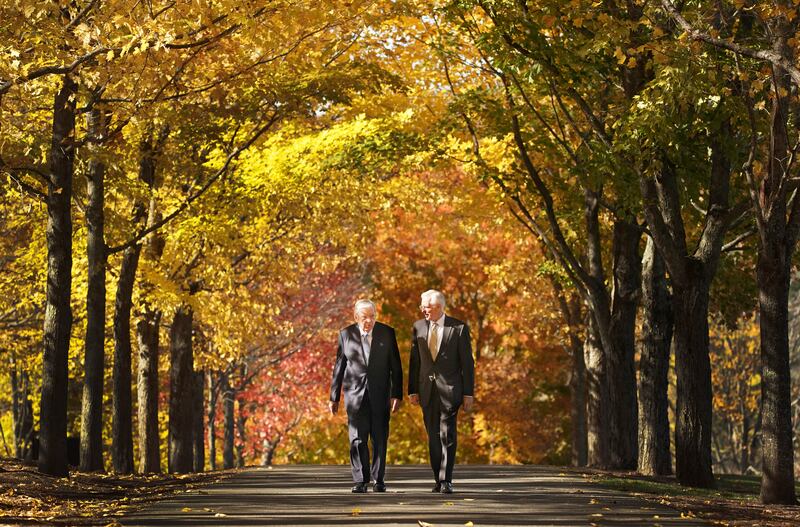 President M. Russell Ballard and Elder D. Todd Christofferson walk down a tree-lined road at the the Joseph Smith Birthplace Memorial. The leaves on the trees are yellow and orange.