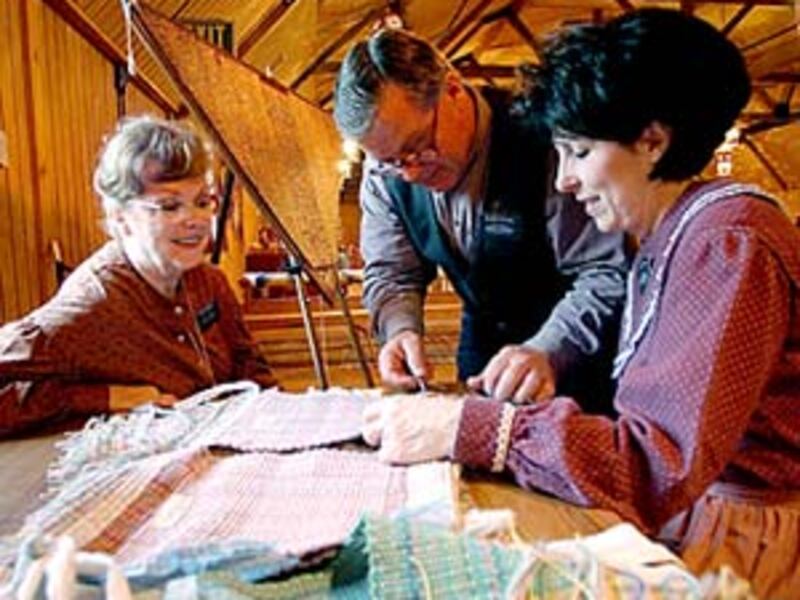 Sister Jean Brimley and Elder Kent and Sister Jeanette Staheli work on weaving done in the manner of