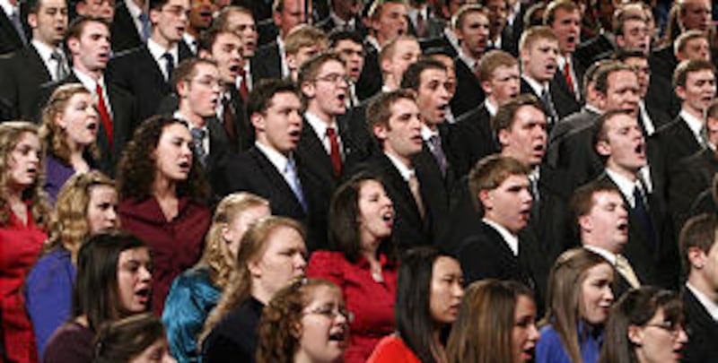 A choir from both BYU and the University of Utah sing at a CES Fireside where Elder Robert D. Hales