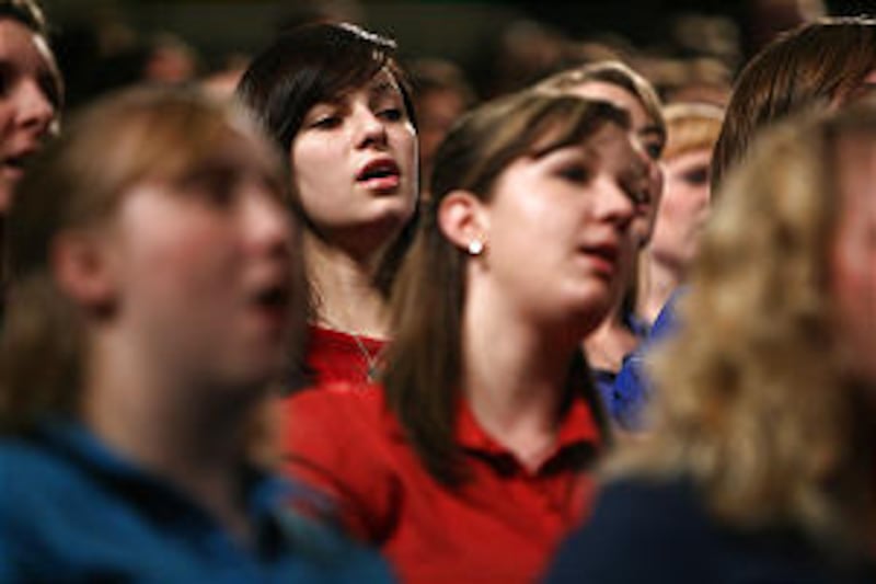 A choir from both BYU and the University of Utah sing at a CES Fireside where Elder Robert D. Hales