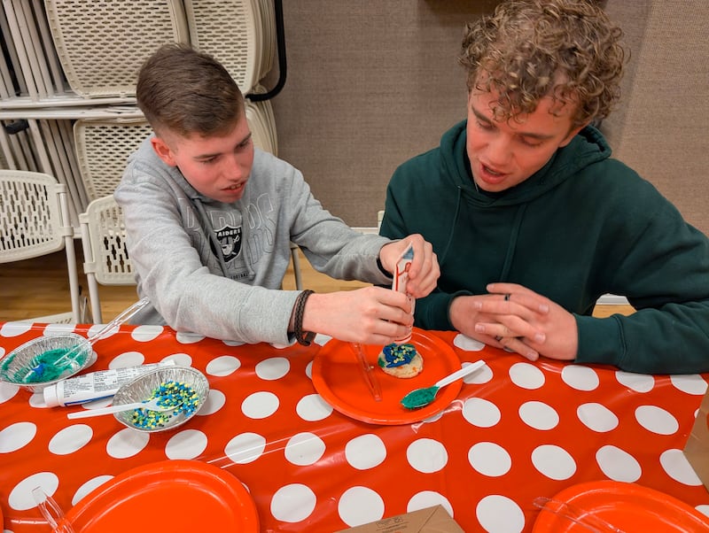A participant and youth counselor decorate cookies during the disability activity program in Las Vegas, Nevada, in February 2026.