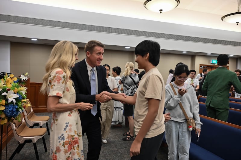 Young Men General President Timothy L. Farnes and his wife, Sister Linsey Farnes, greet a young man after a devotional as part of a ministry assignment to countries in Asia, May 21-31, 2026.