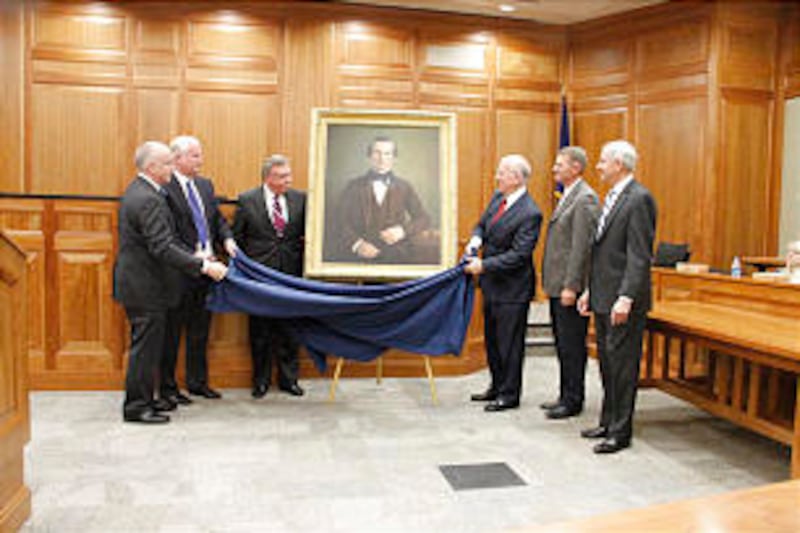 Unveiling painting are Jeffrey N. Walker, left; Michael Hutchings, Kim R. Wilson and Richard Lambert