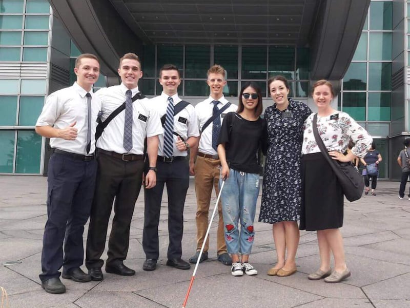 Missionaries from the Taiwan Taipei Mission stand outside the Taipei 101 skyscraper with Shu Ting, a