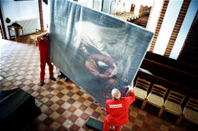 Movers remove Bloch altar painting of "Christ in Gethsemane" from a Lutheran church in Odense, Denma