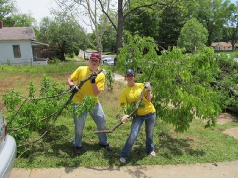 Volunteers work in Ms. Collins' yard.