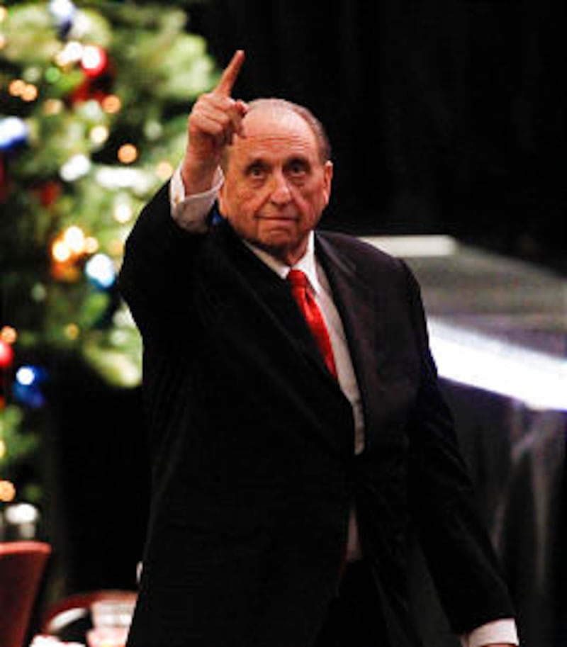 President Monson points up at the audience after the devotional. First Presidency's Christmas devoti