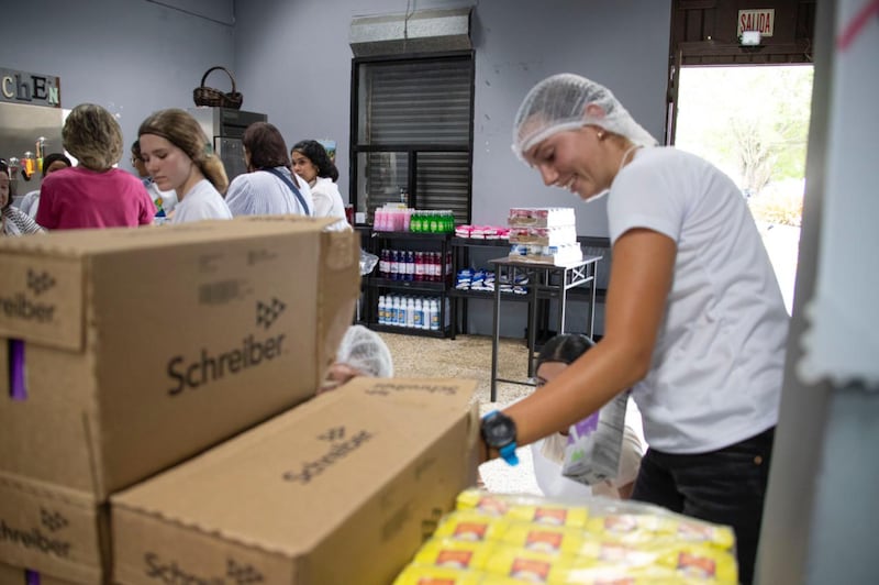Youth package food during a community service activity in Naguabo, Puerto Rico, on Saturday, May 16, 2026.