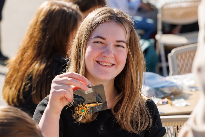 A high school student holds up a jewelry card she made during a service project in Meridian, Idaho, Friday, Feb. 27, 2026.