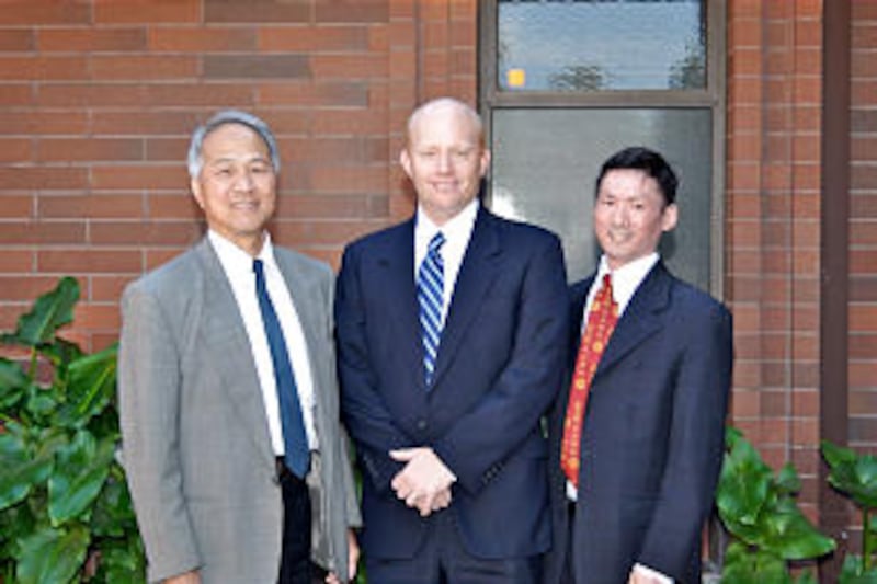 President Greg Byers, center, of the new Yale Branch, Irvine California Stake, is accompanied by cou