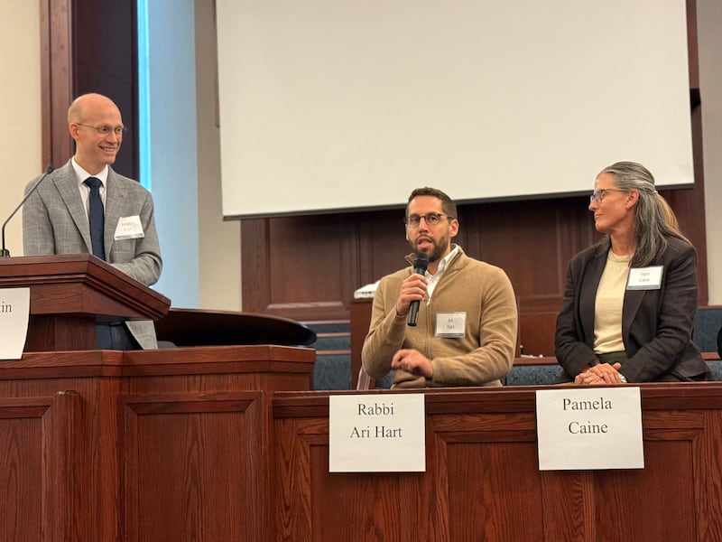 BYU's Justin Dyer, Rabbi Ari Hart and Pamela Caine sit on the stand and address the audience during an interfaith gathering in Chicago, Illinois, on Oct. 14, 2026.