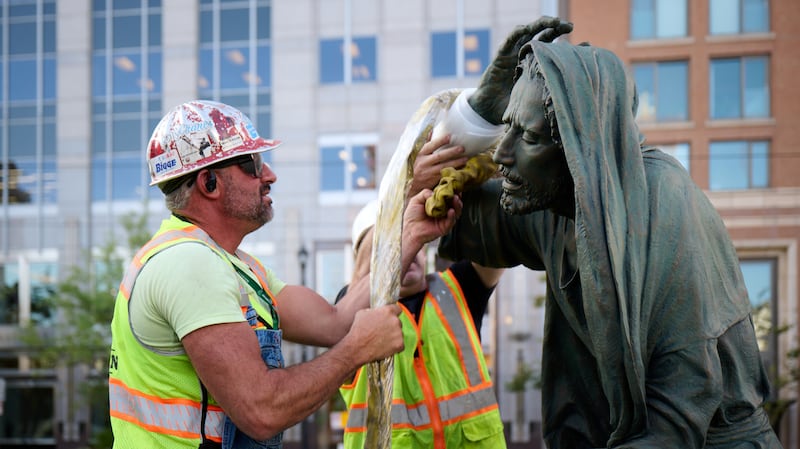 Crew members install the “Jesus Christ in Gethsemane” statue, created by wife-and-husband duo Stephani and Roger Hunt, just south of the Salt Lake Temple on Wednesday, Sept. 17, 2025.