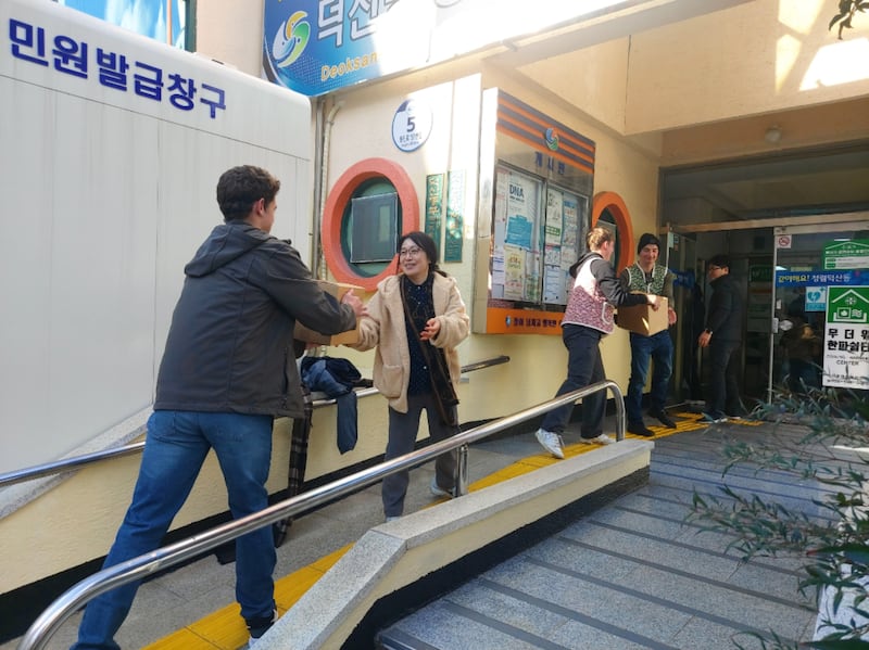 Members and missionaries from the Changwon Korea Stake transfer boxes of kimchi in Changwon, South Korea on Dec. 12, 2025